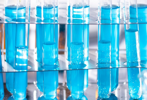 Test tubes full of blue liquid.